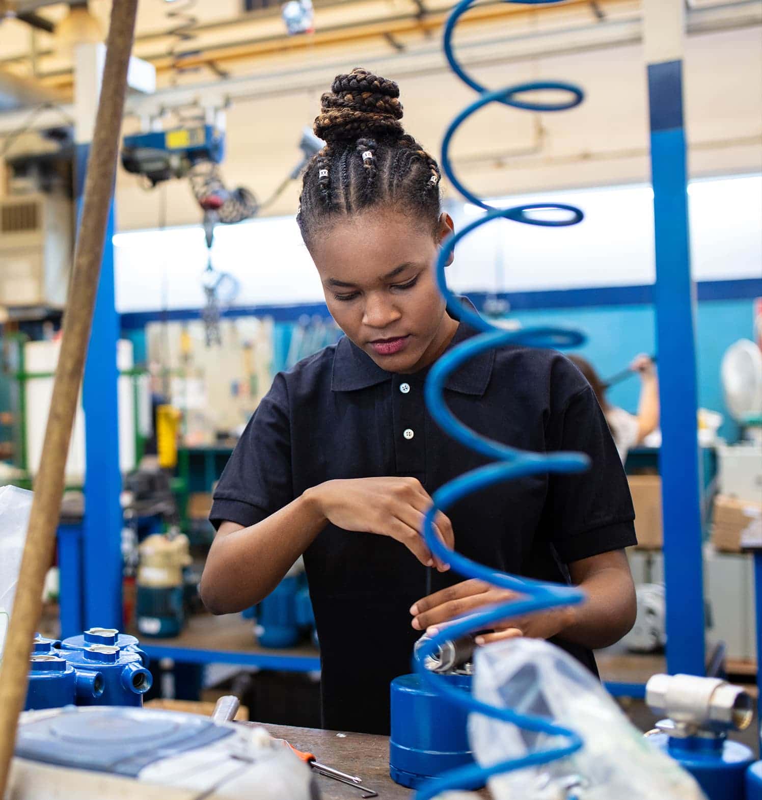 Photo of a woman at work building a machine.